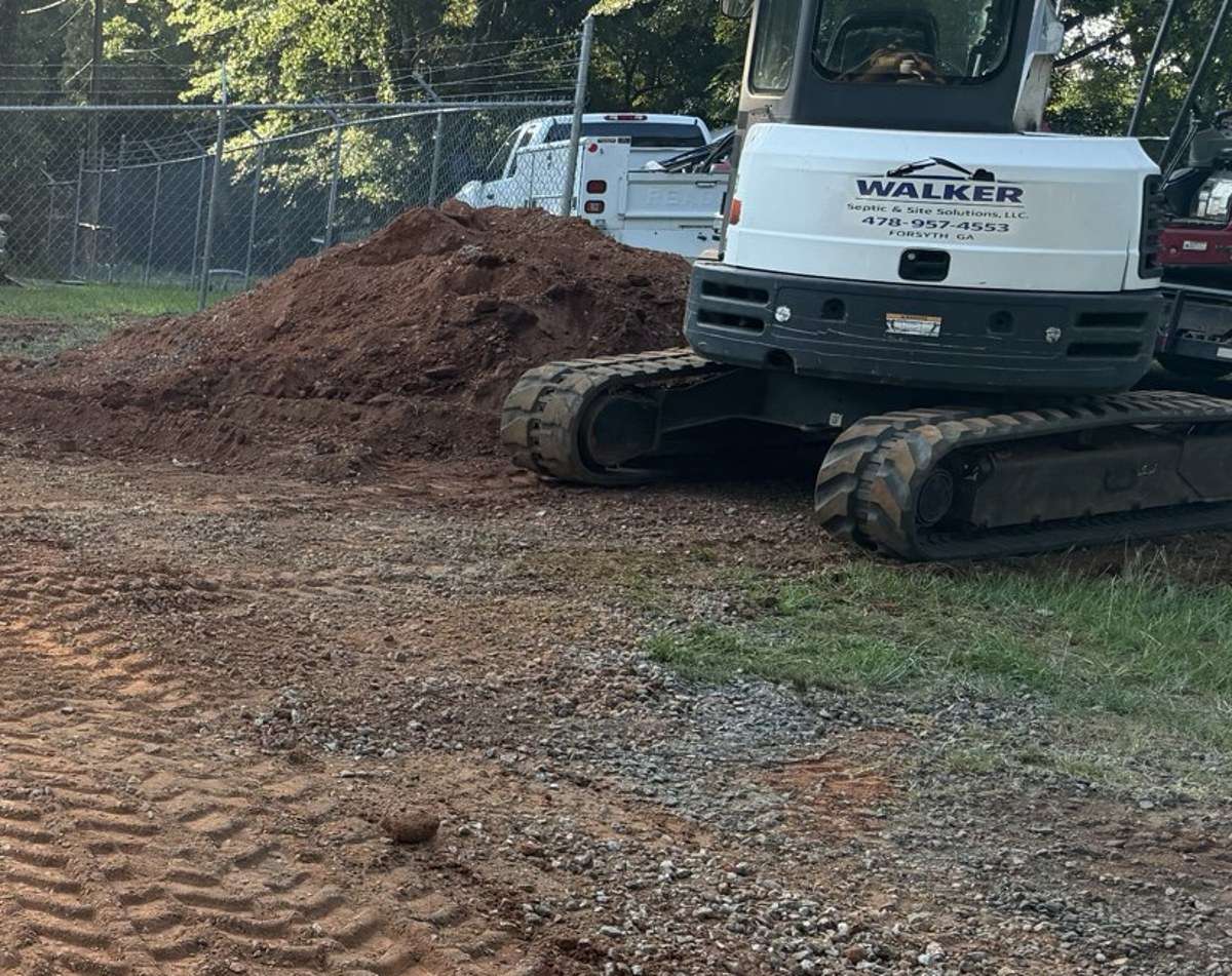 Walker Septic excavator with the company logo